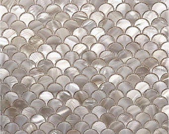 May include: White iridescent mosaic tiles in a fish scale pattern. The tiles are made of mother of pearl and have a subtle shimmer.