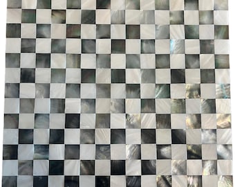 May include: A square, checkered pattern with alternating black, white, and iridescent squares. The squares are arranged in a grid, creating a classic chessboard design. The surface has a glossy finish, reflecting light and adding depth to the design.