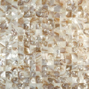 May include: A sheet of iridescent white and gold mother of pearl tile. The tiles are arranged in a checkered pattern.
