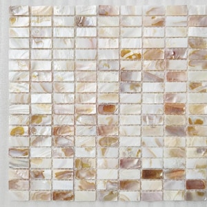 May include: A sheet of white and beige iridescent mother of pearl tile mosaic. The tiles are rectangular and arranged in a grid pattern.