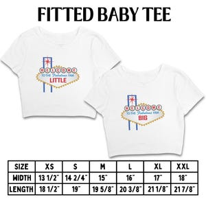 May include: Two white fitted baby tees with a Las Vegas sign design. One says "LITTLE" and the other says "BIG". The sign is gold with red, blue, and white accents. Size chart included.