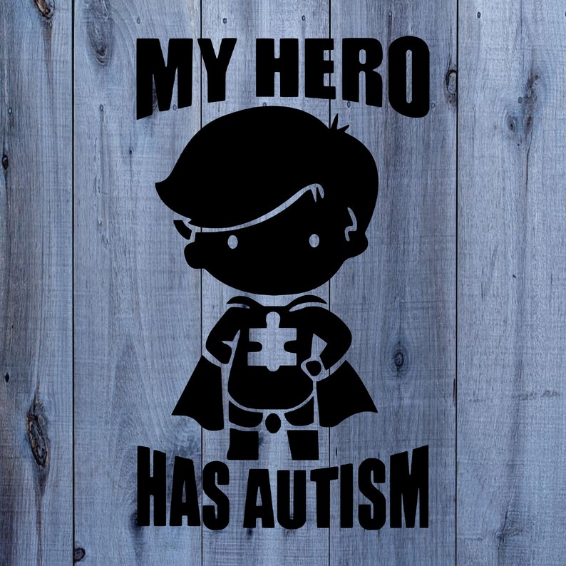 May include: Black and white graphic design on a wood background. The design features a superhero silhouette with a puzzle piece on their chest and the text "My Hero Has Autism".