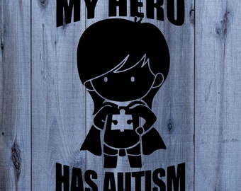 May include: Black and white graphic on a wood background. A silhouette of a superhero with a puzzle piece on their chest. The text reads "My hero has autism."