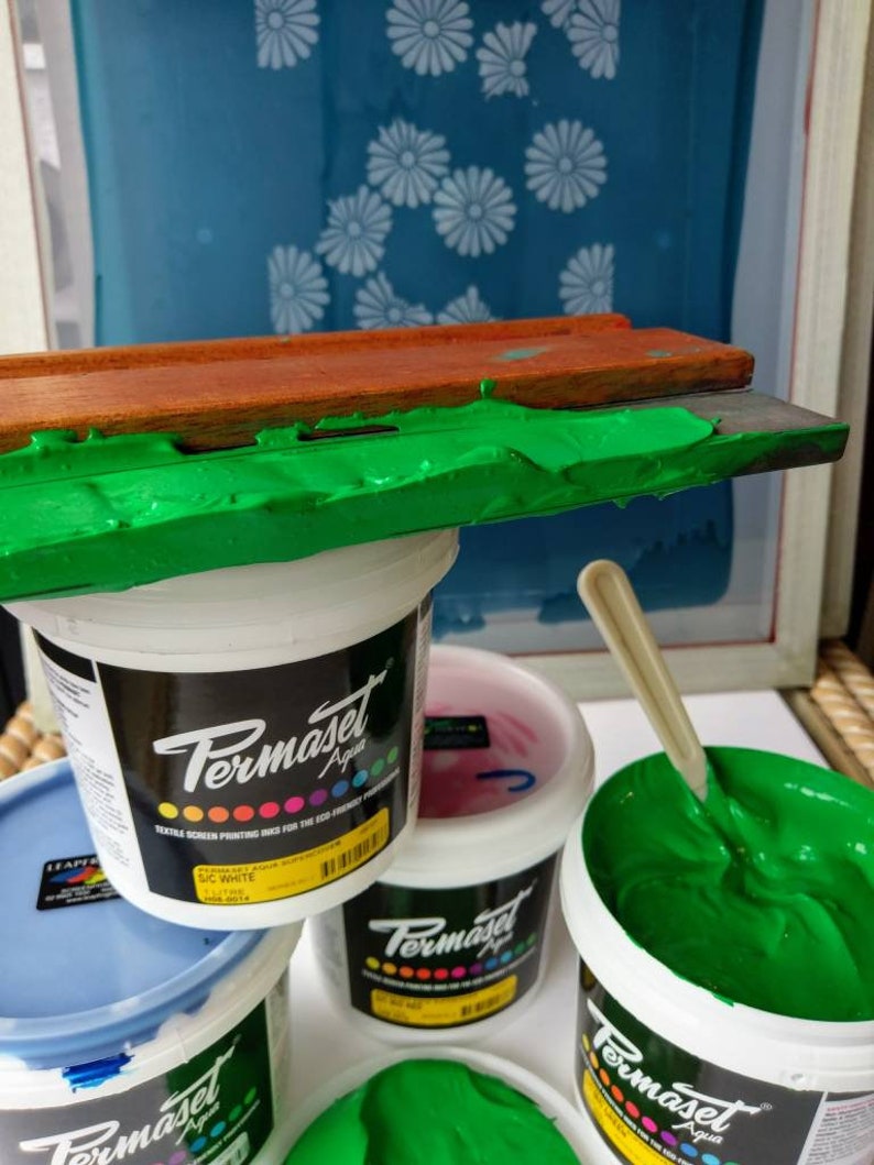 May include: Four containers of green, blue, pink, and white screen printing ink. The containers are labeled "Permaset Aqua" and "SIC White".
