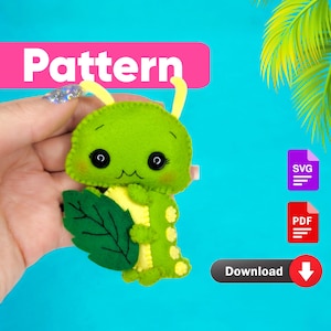 May include: A green felt caterpillar with yellow accents and a leaf. The caterpillar has a cute face with black eyes and a smile. The text "Pattern" is in pink at the top of the image. The text "Download" is in blue at the bottom of the image.