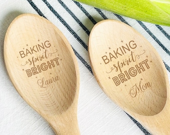 May include: Two wooden spoons with the text "Baking spirit bright" engraved on them. One spoon says "Laura" and the other says "Mom".