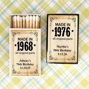May include: Two matchboxes, one open and one closed, with vintage-style labels. The open box reads "MADE IN 1968" and "Johnny's 70th Birthday 11.24.25." The closed box reads "MADE IN 1976" and "Martha's 50th Birthday 9.12.26."