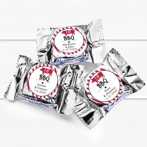 May include: Three silver foil-wrapped chocolate candies with red and white striped labels. Each label features a red pig illustration and the text "I  BBQ" with a star and the names of a couple and their wedding date.