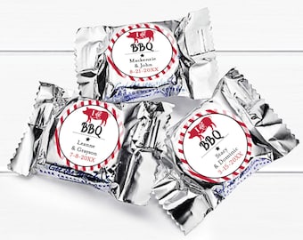 May include: Three silver foil-wrapped chocolate candies with red and white striped labels. Each label features a red pig illustration and the text "I  BBQ" with a star and the names of a couple and their wedding date.