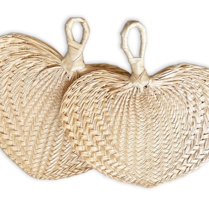 May include: Two woven heart-shaped fans made of natural straw. The fans are closed and have a woven handle.