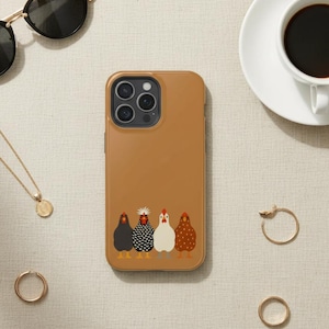 May include: A brown phone case featuring a whimsical illustration of five chickens in a row. The case is surrounded by accessories, including sunglasses, a gold necklace, rings, and a cup of coffee.