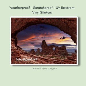 May include: A vinyl sticker featuring a scenic view of Arches National Park in Utah. The sticker shows a red rock archway with a sunset sky in the background. The text "Arches National Park" is printed on the sticker. The sticker is weatherproof, scratchproof, and UV resistant.