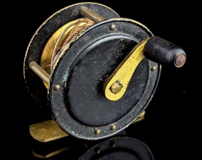 Antique miniature side cast fishing reel, Black lacquer and gilt brass