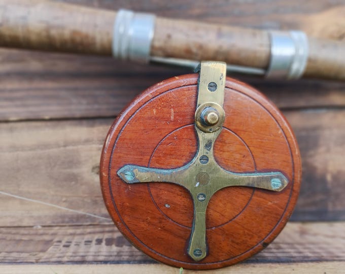 Antique star back fishing reel, mahogany and brass