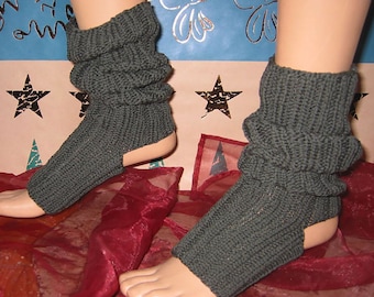 May include: A pair of dark green knitted leg warmers with a cut-out at the heel. The leg warmers are gathered at the top and are shown on a mannequin.