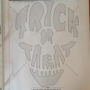 May include: A Halloween-themed pumpkin carving pattern featuring a skull design. The words "TRICK OR TREAT" are integrated into the skull's features. The difficulty level is indicated as easy, moderate, or challenging.