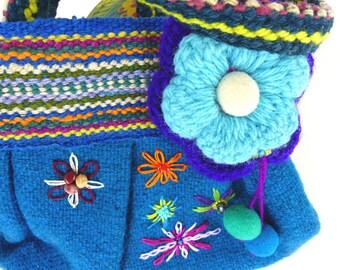 Fun flower hand embroidered and beaded top handle purse. Woven and lined teal bag with knit flowers, felted wool dangle balls.