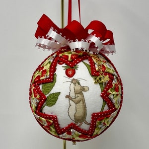 May include: A handmade Christmas bauble featuring a mouse with a red and white polka dot background. The bauble is decorated with a red bow and a gold charm with the year 2024.