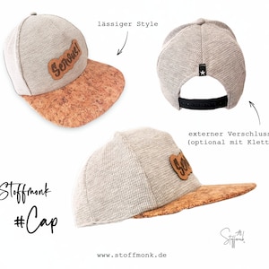 Puede incluir: Una gorra de béisbol gris y marrón con visera de corcho y un parche de cuero marrón que dice "Serous!" en la parte delantera. La gorra tiene una correa ajustable negra en la parte posterior. La gorra se muestra desde diferentes ángulos.