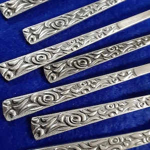 42 piece service for 8 vintage Walco abstract floral stainless flatware set