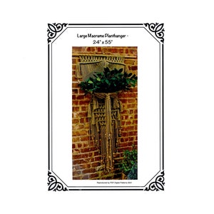 May include: A large macrame plant hanger, approximately 24 inches wide and 55 inches long, displayed against a brick wall. The plant hanger is made of tan-colored rope and holds a lush green plant. The text "Large Macrame Planthanger - 24" x 55"" is visible.