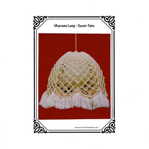 May include: A cream-colored macrame lamp with a fringed bottom. The lamp has a geometric pattern and is suspended from a single cord. The text "Macrame Lamp - Savoir-Faire" is displayed at the top of the image.