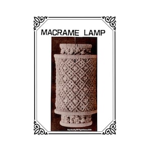 May include: A macrame lamp with a cylindrical shade and decorative top and base. The lamp is made of off-white woven material, with a geometric pattern on the shade. The text "MACRAME LAMP" is at the top.