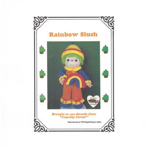 May include: A crochet doll named "Rainbow Slush" is featured on a white background. The doll has a yellow and green hat, green hair, and a rainbow design on its chest. The doll is wearing orange pants and blue sleeves. The text "Rainbow Slush" is at the top.