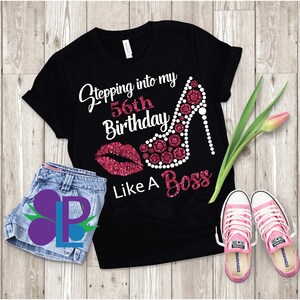May include: Black t-shirt with a pink glitter design of a high heel shoe and lips. The text "Stepping into my 56th Birthday Like A Boss" is on the shirt.