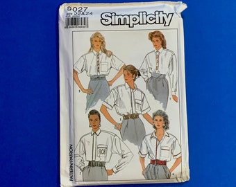 May include: A Simplicity sewing pattern packet, featuring illustrations of women's shirts. The packet is white with the word "Simplicity" in a bold font. The pattern number is 9027, and the size is 22 & 24.