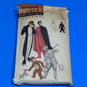 May include: Vintage Butterick printed pattern for costumes. The package features illustrations of a penguin, devil, cat, and monkey costumes. The package is tan with the Butterick logo and text. The breast size is 30 inches.