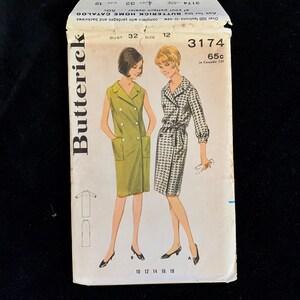 May include: Vintage Butterick sewing pattern envelope featuring illustrations of two dresses. The envelope is white with the Butterick logo and pattern number 3174. The bust size is 32, and the size is 12. The price is 65 cents.