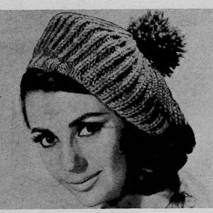 May include: A black and white image of a knitted hat with a pom-pom. The hat has a ribbed design and is worn by a person. The image is a close-up shot, focusing on the hat and the person's face.