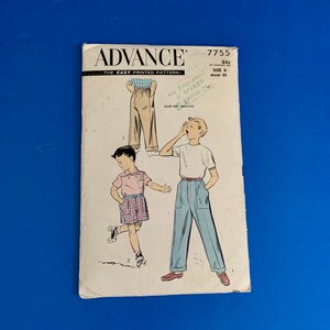 May include: Vintage Advance sewing pattern 7755 for boys' pants and shorts. The cover features illustrations of the garments and the text "ADVANCE THE EASY PRINTED PATTERN!" and "SIZE 6 Waist 22". The pattern is on a blue background.