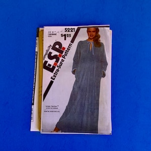 May include: A vintage Simplicity ESP Extra-Sure Pattern for a Miss's dress. The pattern features a woman in a long, blue dress with a tie at the neckline. The pattern is labeled size 10, 12, 14 and includes Time Saver stretch knit methods.
