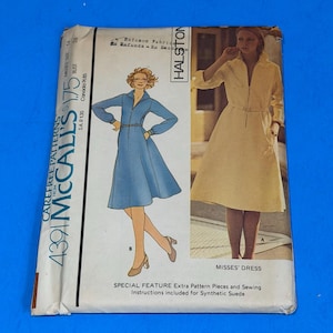 May include: A McCall's 4391 sewing pattern envelope for a dress designed by Halston. The front features illustrations of a blue dress and a yellow dress, with text including 'Carefree Patterns', 'Misses' Dress', and 'Special Feature Extra Pattern Pieces'.