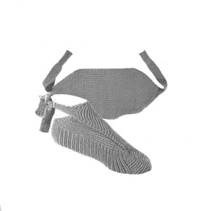 May include: A grayscale image of a knitted slipper and a matching back warmer. The slipper is a light gray color with a ribbed texture on the foot and a smooth texture on the ankle. The back warmer is rectangular with a strap.