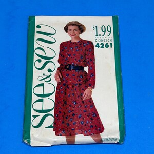 May include: A vintage sewing pattern titled "see & sew" featuring a woman in a red floral dress. The pattern is size C (20-22-24) and is labeled as pattern 4261. The price is $1.99.