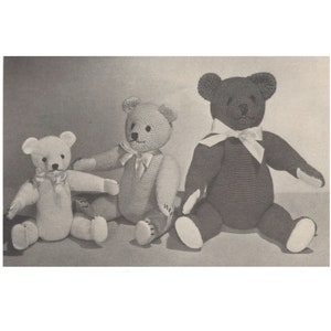 May include: Three handmade teddy bears in varying shades of white, tan, and brown. Each bear has a bow around its neck and is seated with arms outstretched. The bears are crocheted and have a classic teddy bear design.