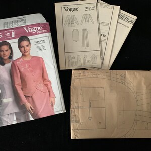 May include: Vogue sewing pattern packet featuring a woman in a pink suit with floral embroidery. The packet includes pattern pieces and instructions for a jacket, skirt, and pants. The pattern number is 7844/1100.