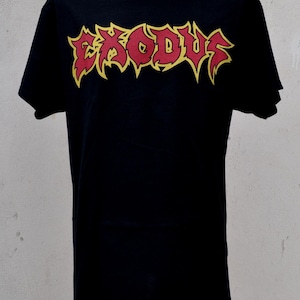 May include: Black t-shirt featuring the word "EXODUS" in a red, stylized font with yellow outlines. The shirt is displayed on a mannequin. The design has a heavy metal aesthetic.