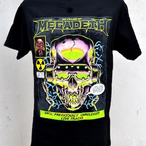 May include: Black t-shirt with a colourful skull graphic, the band name "MEGADETH", and the text "35 YEARS OF". The design includes the text "INCL. PREAVIOUSLY UNRELEASED LIVE TRACKS". The graphic has neon green and purple accents.