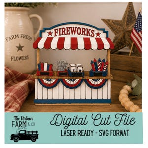 May include: A wooden fireworks stand with a red, white, and blue color scheme. The stand features a sign that reads "FIREWORKS" and is decorated with patriotic bunting. The image also includes a digital cut file for laser cutting.