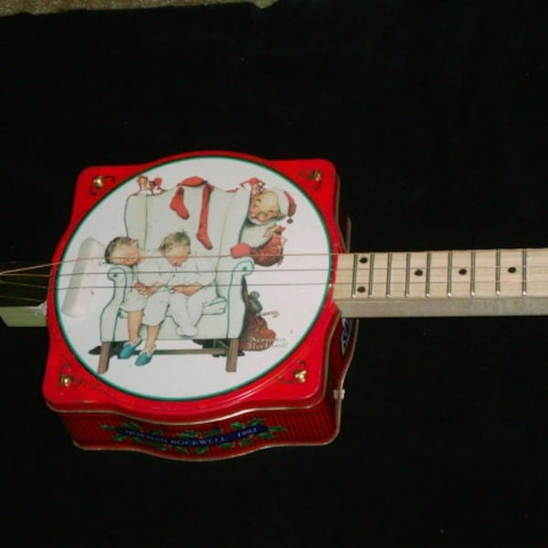 Cigar Box Gitarre mit einer "Norman Rockwell" Can