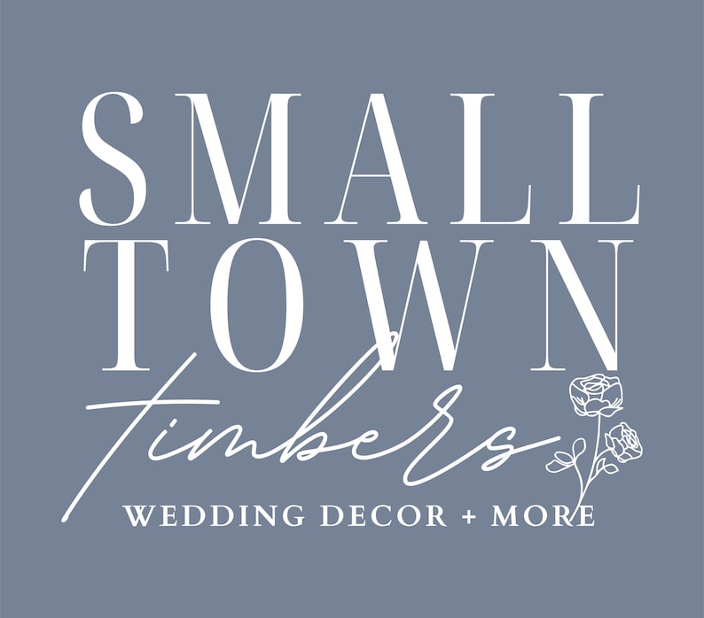 May include: A logo on a dusty blue background featuring the white text SMALL TOWN in a serif font, followed by the word Timbers in a white script font, and the text WEDDING DECOR + MORE below. A white line drawing of two roses is on the right.