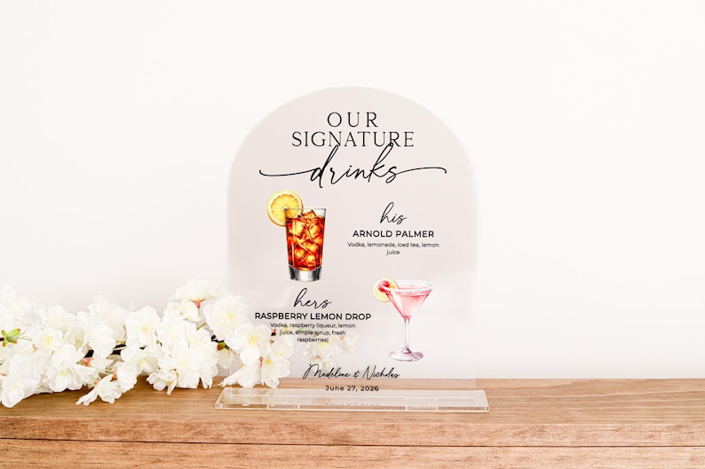 A clear acrylic arch sign offers a minimalist, modern way to display your signature drinks. UV printing provides a crisp, permanent finish with your custom menu, names and date. Perfect for wedding receptions or anniversary parties.
