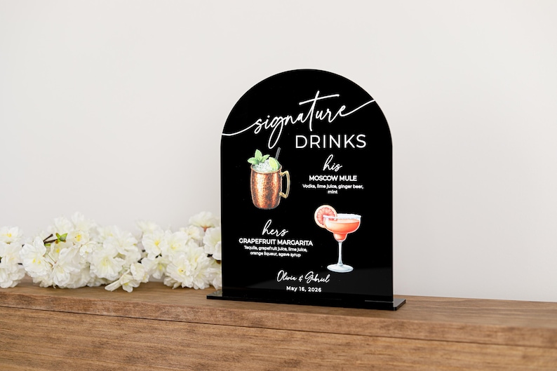 Personalized rectangular acrylic bar sign (white or black) UV printed with a “signature drinks” heading, customizable cocktail illustrations, descriptive text, and space for names and date. Ideal for wedding bars, rehearsal dinners, or bridal showers.