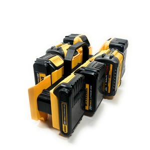 May include: A set of black and yellow 20V MAX Lithium Ion batteries with a black handle. The batteries are arranged in a holder, and the image is taken against a white background.