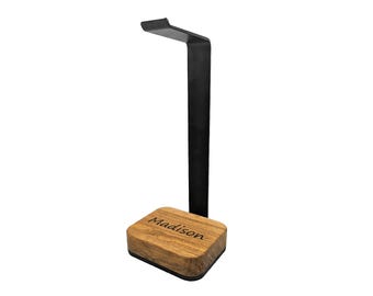 May include: A black metal headphone stand with a wooden base. The base is engraved with the name "Madison".
