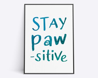 May include: A framed print with a blue watercolor background and the text "Stay paw-sitive" with a paw print in the word "paw".
